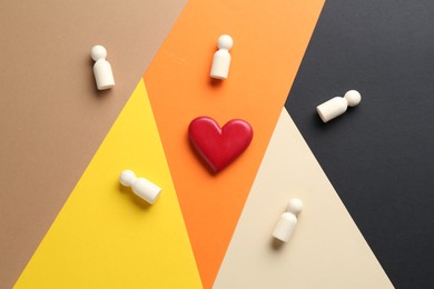 Photo of Tolerance concept. Human figures and heart on colorful background, flat lay