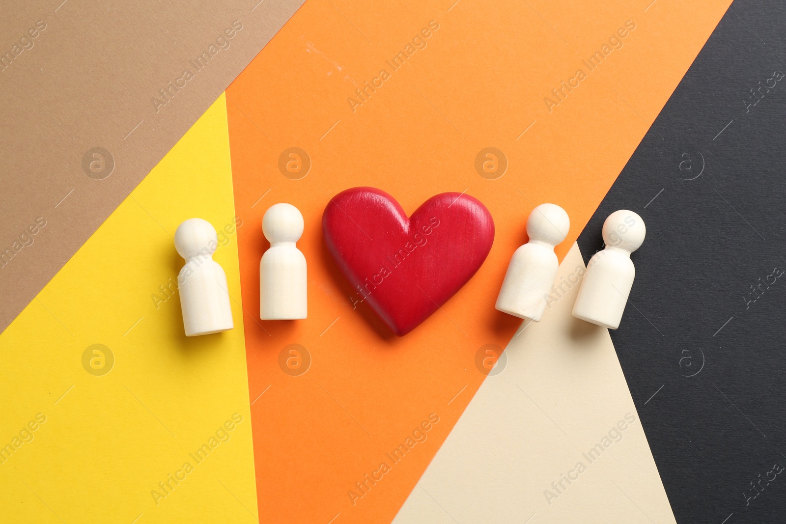 Tolerance concept. Human figures and heart on colorful background, flat lay Photo of Tolerance concept. Human figures and heart on colorful background, flat lay
