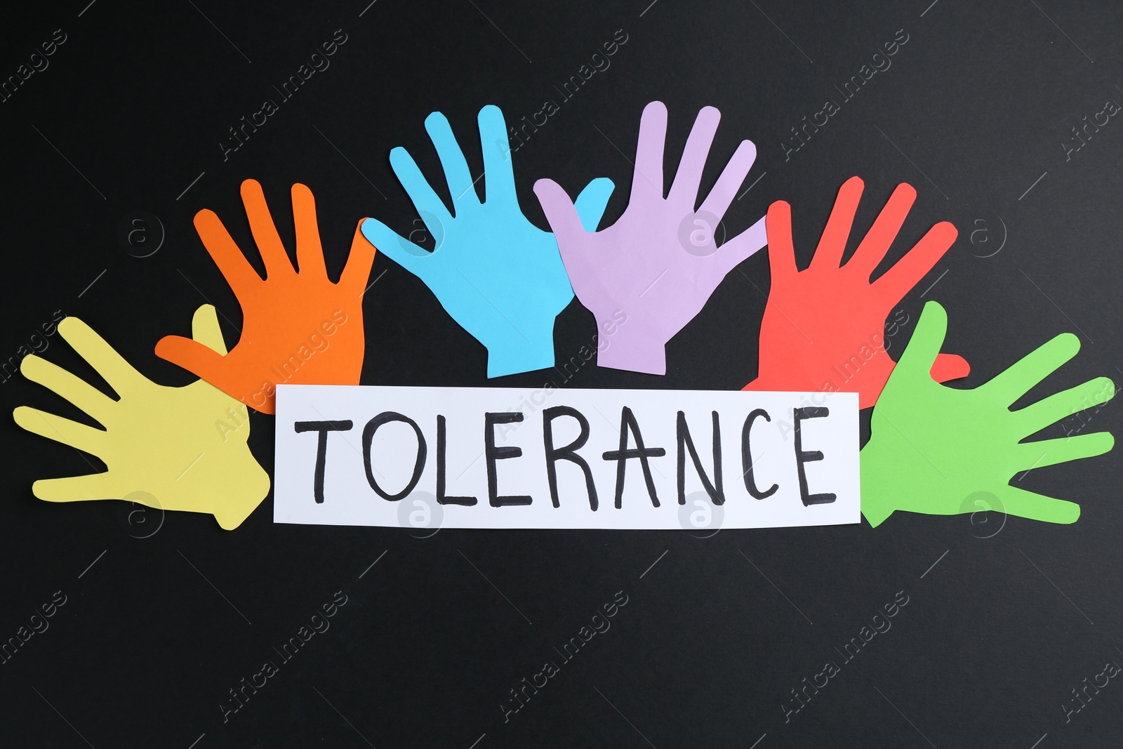 Card with word Tolerance and colorful paper hands on black background, flat lay Photo of Card with word Tolerance and colorful paper hands on black background, flat lay
