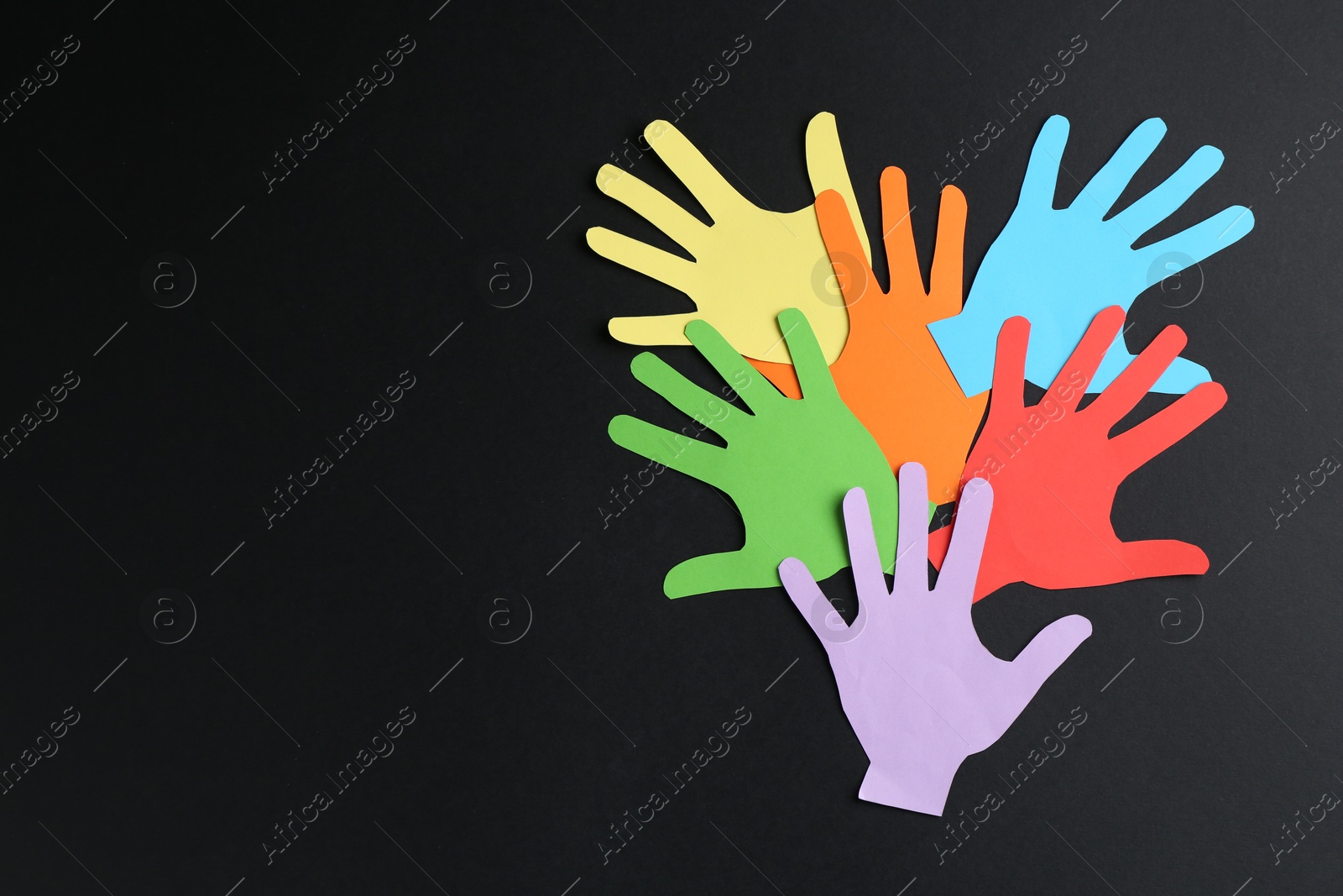 Tolerance concept. Colorful paper hands on black background, flat lay. Space for text Photo of Tolerance concept. Colorful paper hands on black background, flat lay. Space for text