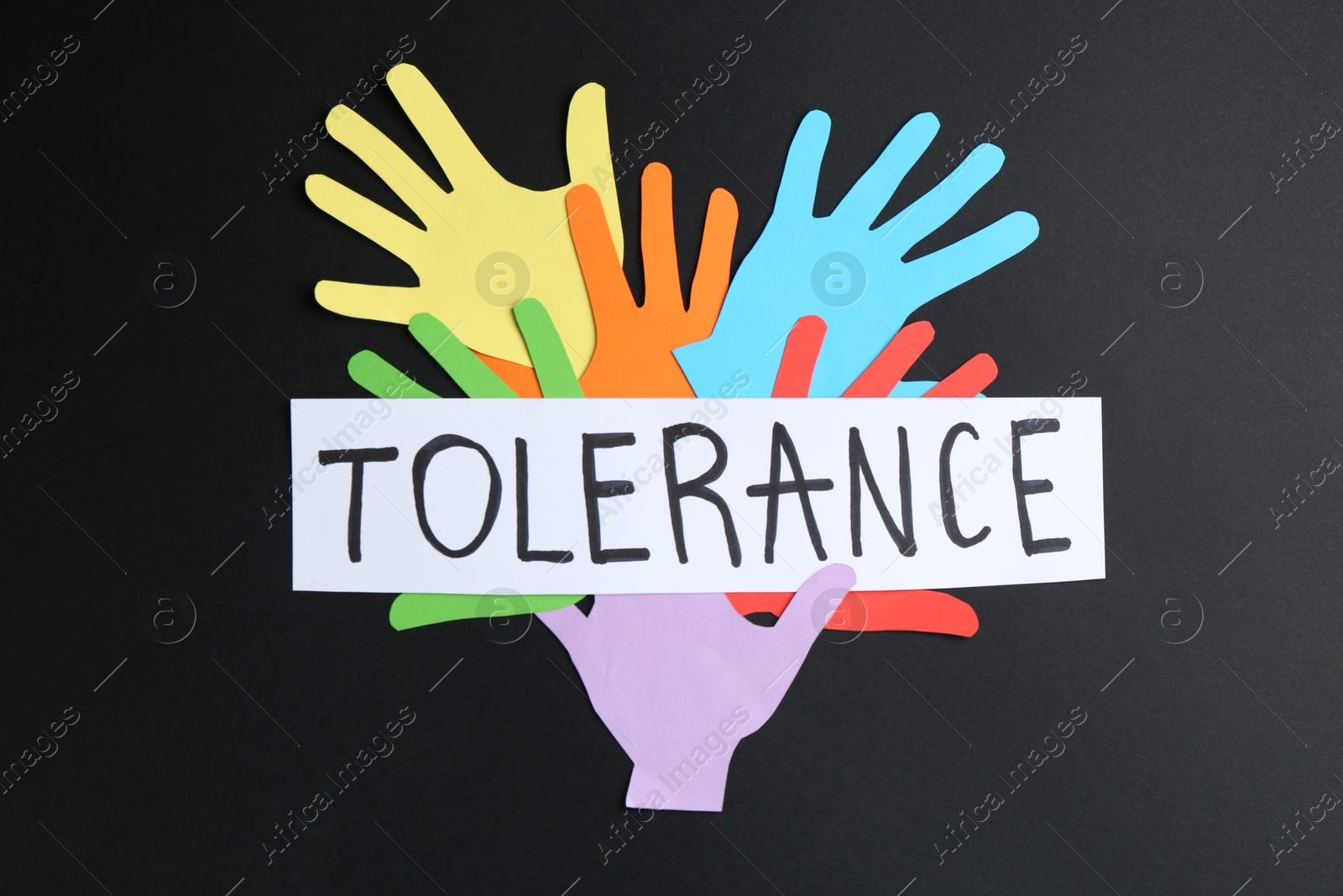 Card with word Tolerance and colorful paper hands on black background, flat lay Photo of Card with word Tolerance and colorful paper hands on black background, flat lay