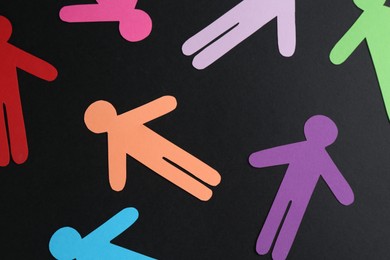 Photo of Tolerance concept. Colorful human figures on black background, flat lay