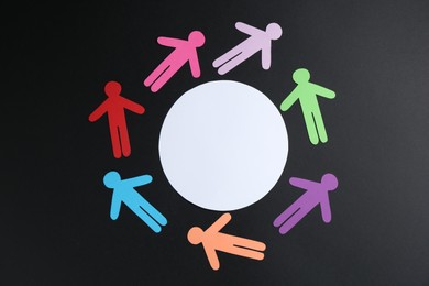 Photo of Tolerance concept. Colorful human figures and empty card on black background, flat lay. Space for text