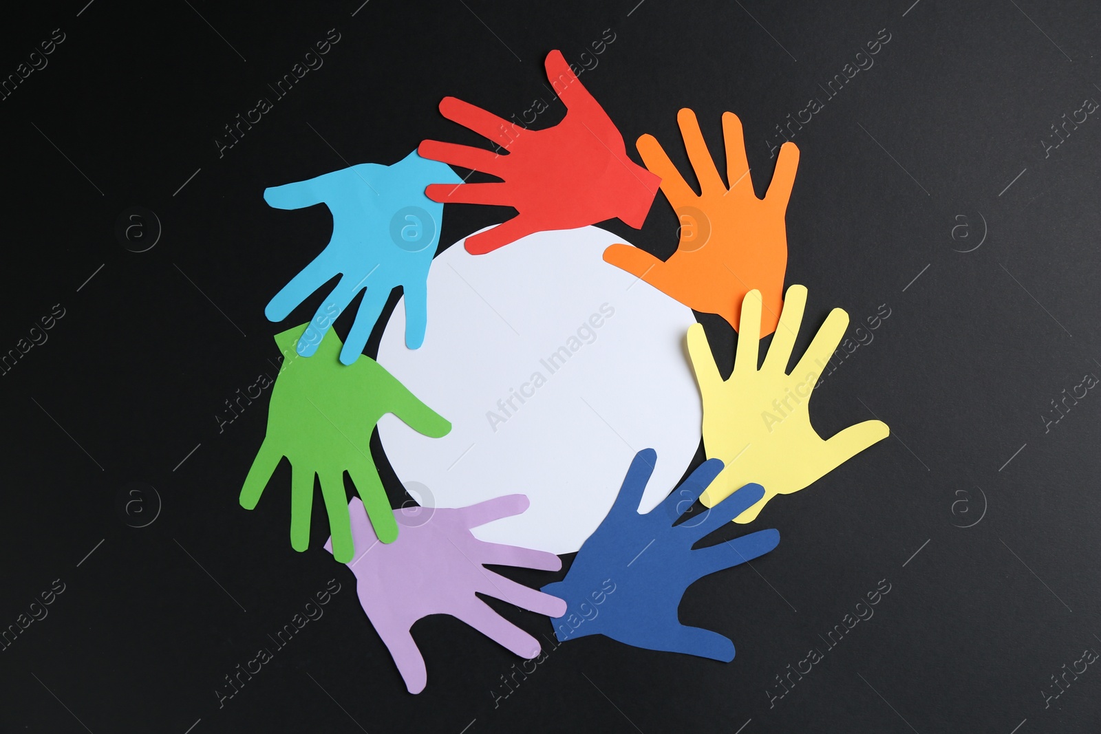 Tolerance concept. Colorful paper hands and empty card on black background, flat lay. Space for text Photo of Tolerance concept. Colorful paper hands and empty card on black background, flat lay. Space for text