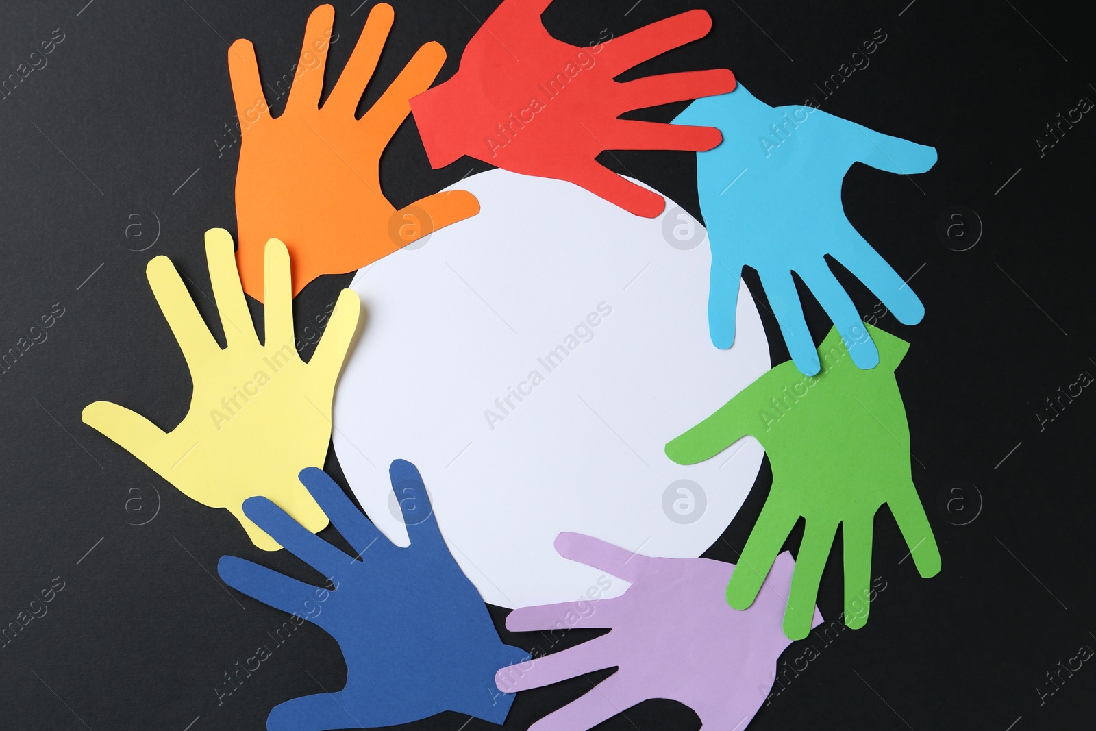 Tolerance concept. Colorful paper hands and empty card on black background, flat lay. Space for text Photo of Tolerance concept. Colorful paper hands and empty card on black background, flat lay. Space for text