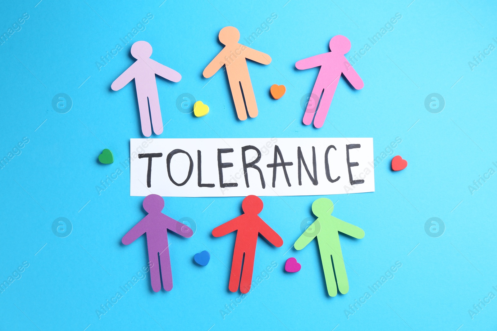 Card with word Tolerance, colorful human figures and hearts on light blue background, flat lay Photo of Card with word Tolerance, colorful human figures and hearts on light blue background, flat lay