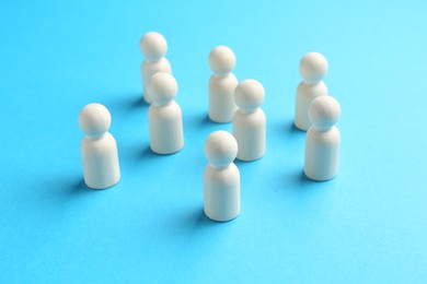 Photo of Tolerance concept. Human figures on light blue background, closeup