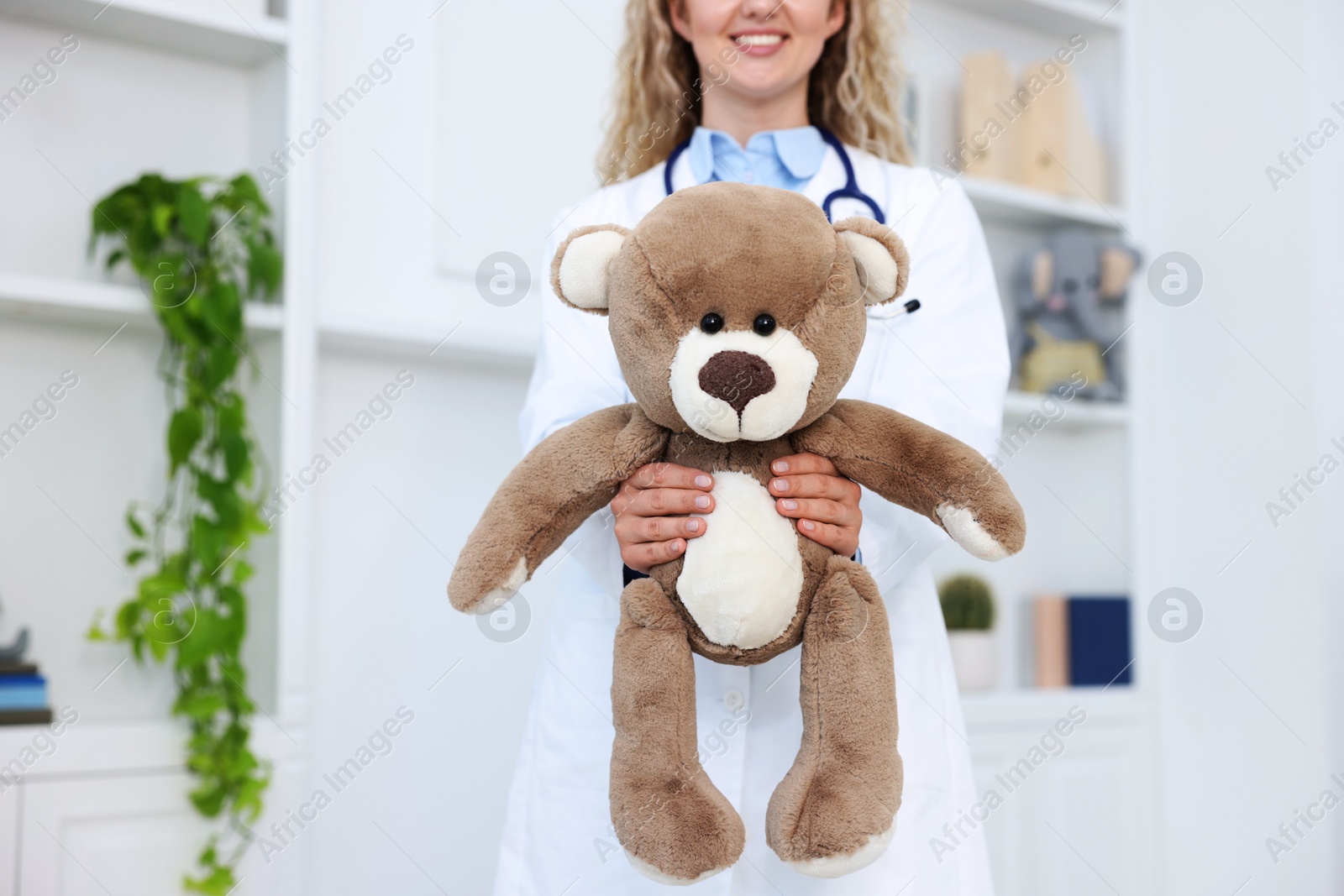 Pediatrician with toy bear in hospital, closeup Photo of Pediatrician with toy bear in hospital, closeup