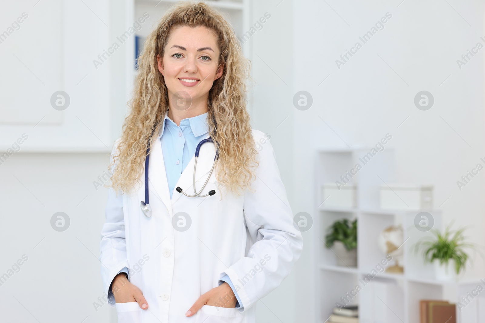 Portrait of professional pediatrician with stethoscope in hospital. Space for text Photo of Portrait of professional pediatrician with stethoscope in hospital. Space for text