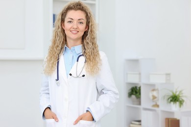 Photo of Portrait of professional pediatrician with stethoscope in hospital. Space for text