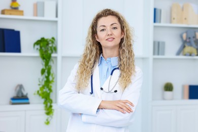 Photo of Portrait of professional pediatrician with stethoscope in hospital