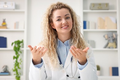 Photo of Pediatrician having video call with patient, view from camera