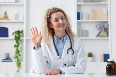Photo of Pediatrician having video call with patient, view from camera