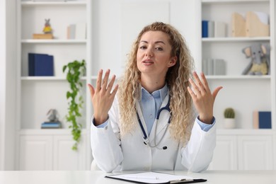 Photo of Pediatrician having video call with patient, view from camera