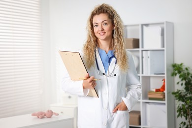 Photo of Portrait of professional pediatrician with stethoscope and clipboard in hospital