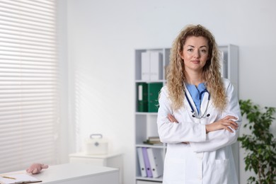 Photo of Portrait of professional pediatrician with stethoscope in hospital. Space for text