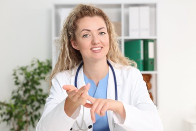 Photo of Pediatrician having video call with patient, view from camera