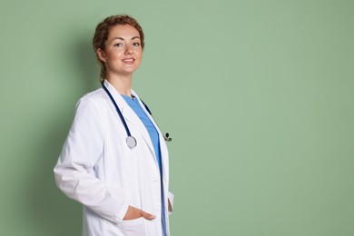 Photo of Portrait of professional pediatrician with stethoscope on olive background. Space for text