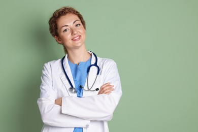Photo of Portrait of professional pediatrician with stethoscope on olive background. Space for text