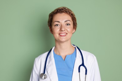 Photo of Portrait of professional pediatrician with stethoscope on olive background