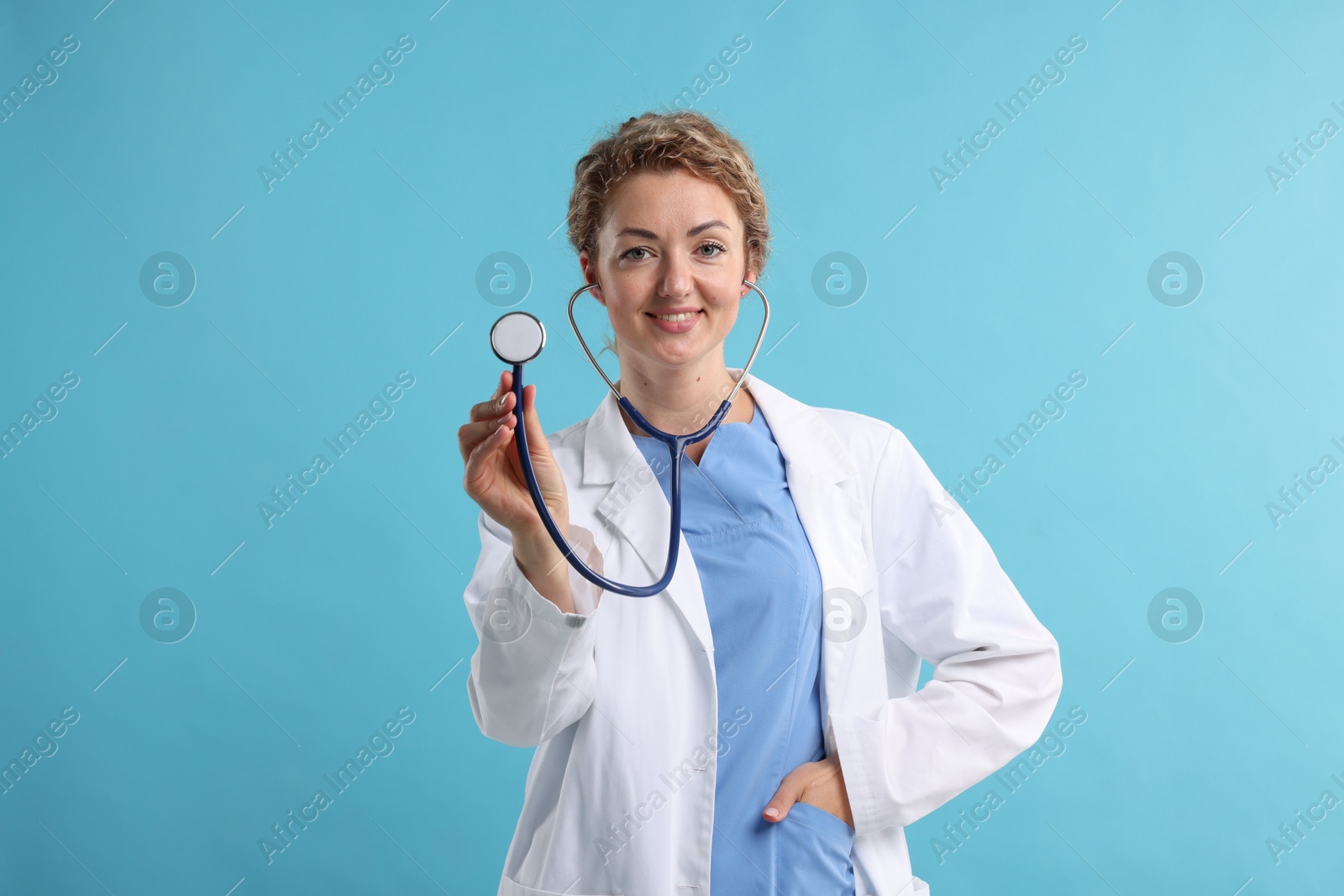 Portrait of professional pediatrician with stethoscope on light blue background Photo of Portrait of professional pediatrician with stethoscope on light blue background