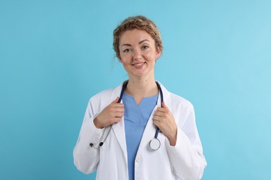 Photo of Portrait of professional pediatrician with stethoscope on light blue background