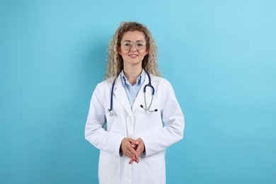 Photo of Pediatrician with stethoscope on light blue background