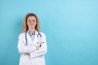 Photo of Pediatrician with stethoscope on light blue background. Space for text
