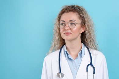 Photo of Pediatrician with stethoscope on light blue background. Space for text