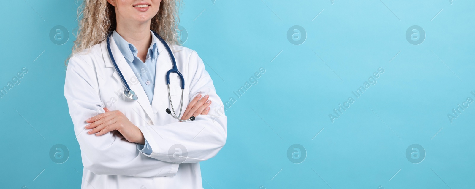 Pediatrician on light blue background, closeup. Space for text Photo of Pediatrician on light blue background, closeup. Space for text