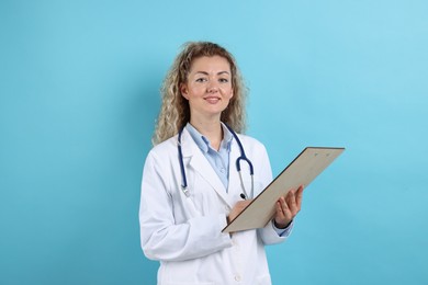 Photo of Pediatrician with clipboard on light blue background