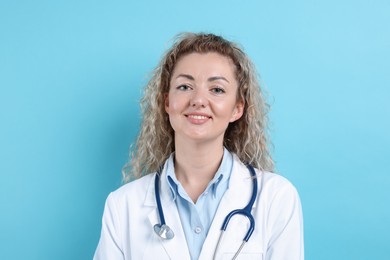 Photo of Pediatrician with stethoscope on light blue background