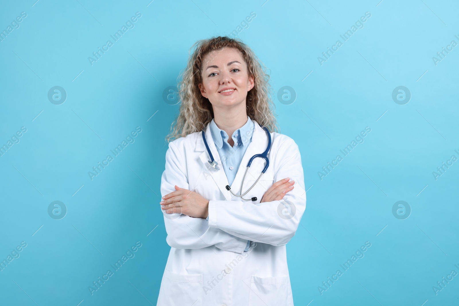 Portrait of pediatrician on light blue background Photo of Portrait of pediatrician on light blue background
