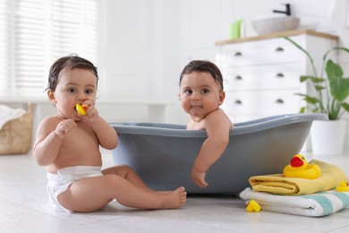 Photo of Cute little twin brothers bathing at home