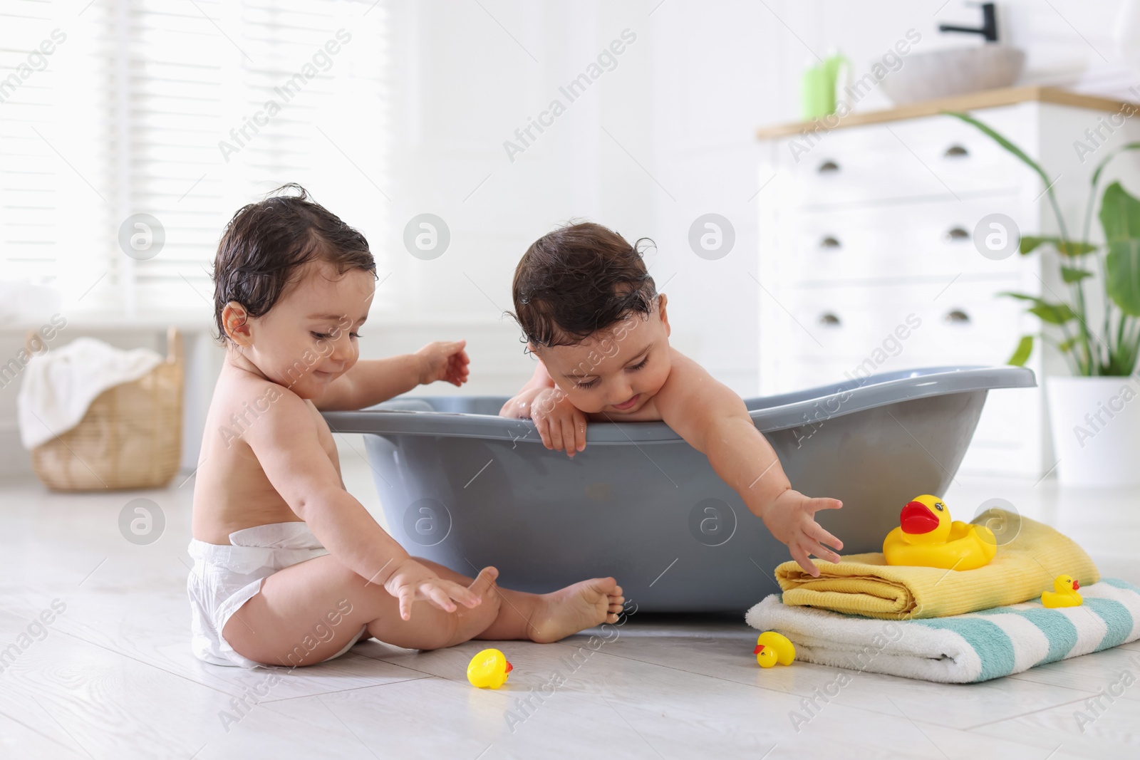 Cute little twin brothers bathing at home Photo of Cute little twin brothers bathing at home