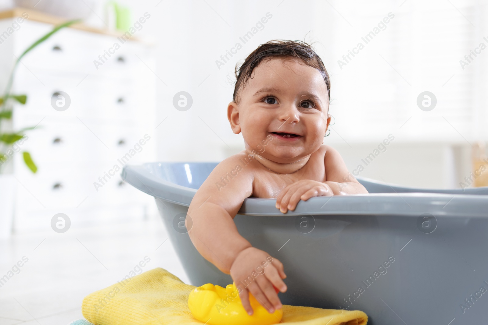 Cute little baby bathing in tub at home Photo of Cute little baby bathing in tub at home