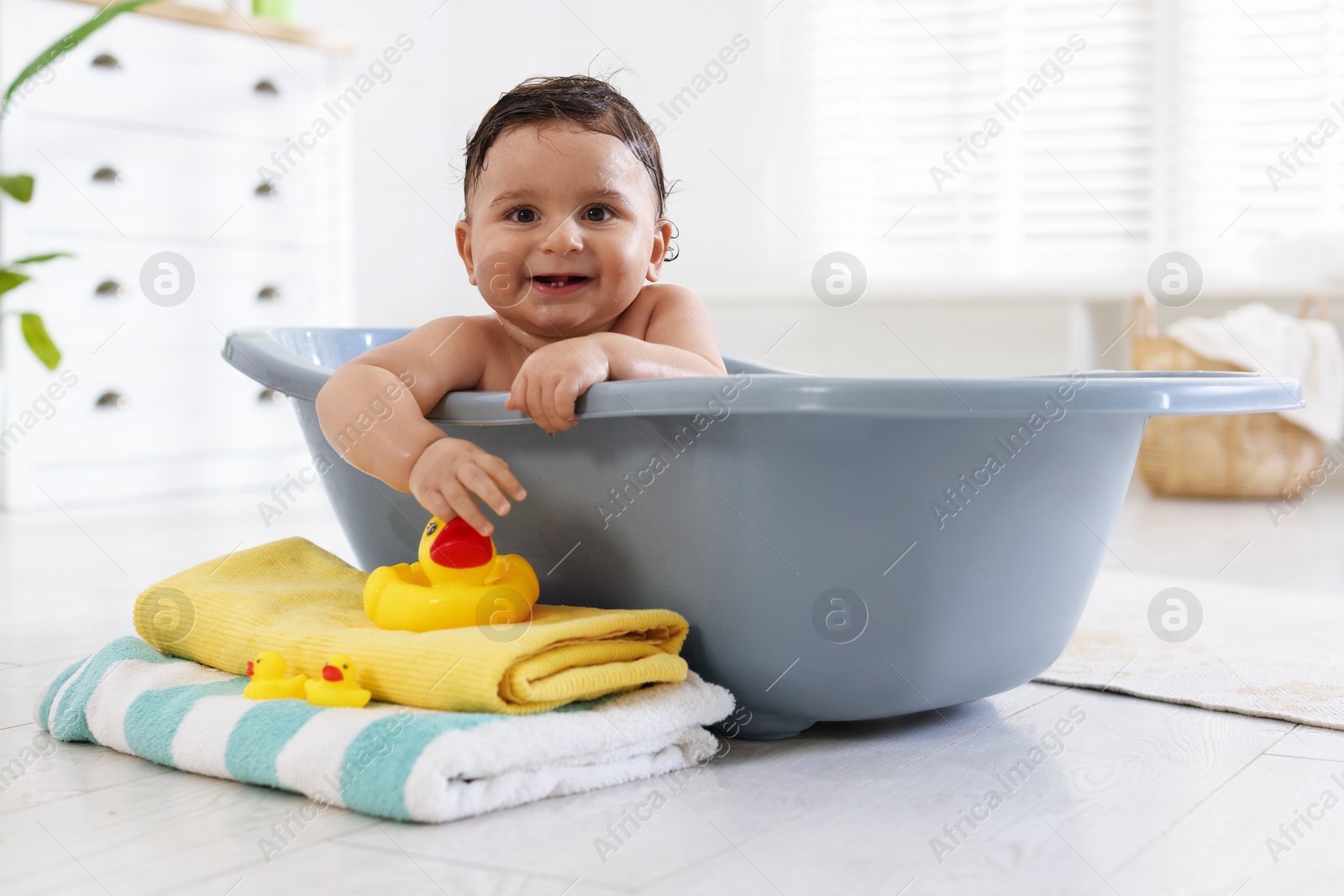 Cute little baby bathing in tub at home Photo of Cute little baby bathing in tub at home