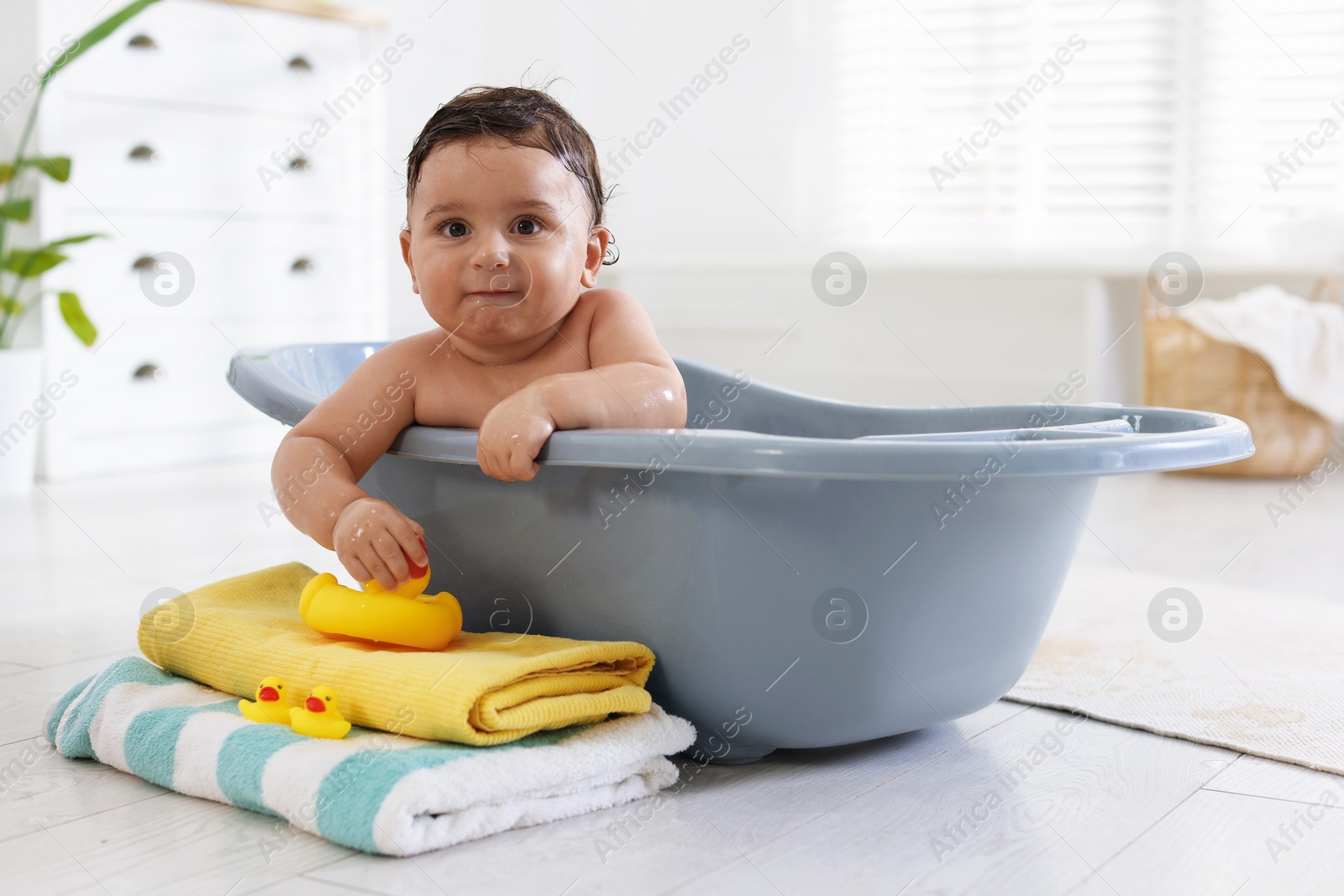Cute little baby bathing in tub at home Photo of Cute little baby bathing in tub at home
