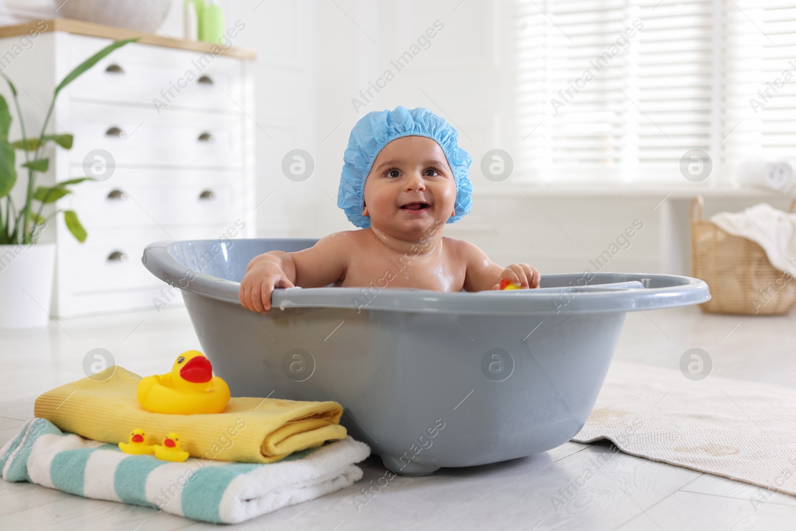 Cute little baby in cap bathing at home Photo of Cute little baby in cap bathing at home