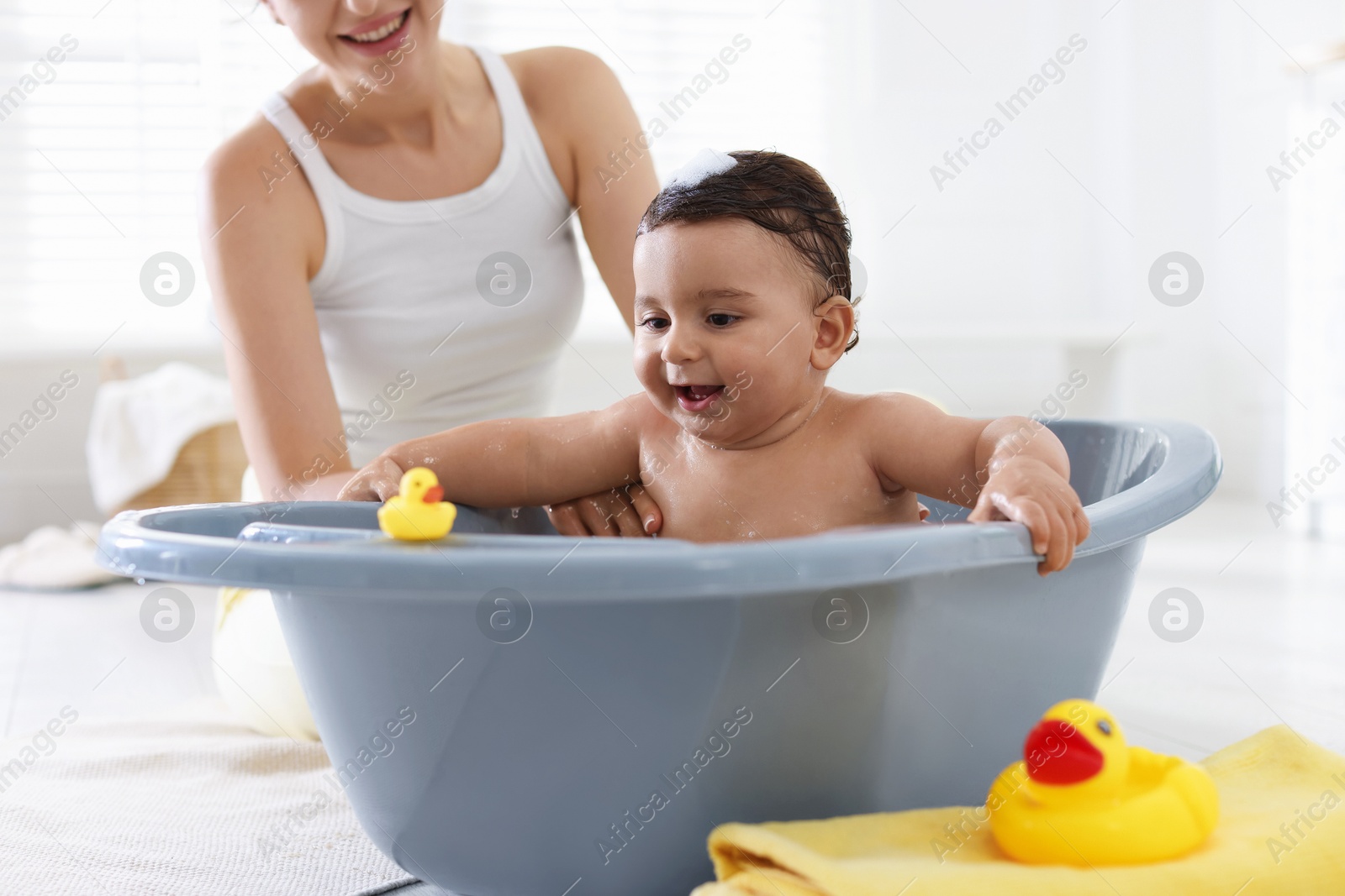 Mom bathing her little baby at home, closeup Photo of Mom bathing her little baby at home, closeup
