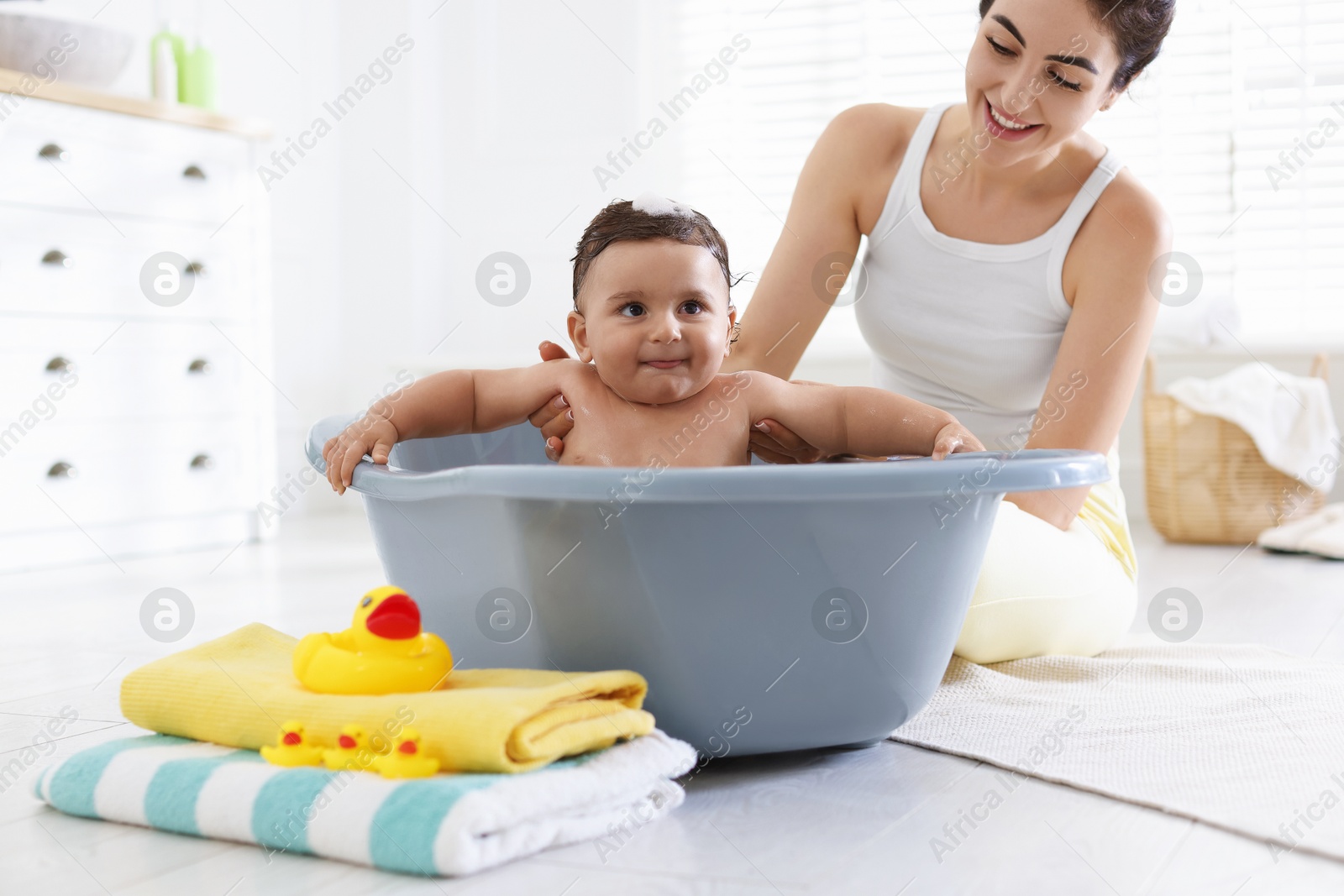 Mom bathing her little baby at home, closeup Photo of Mom bathing her little baby at home, closeup