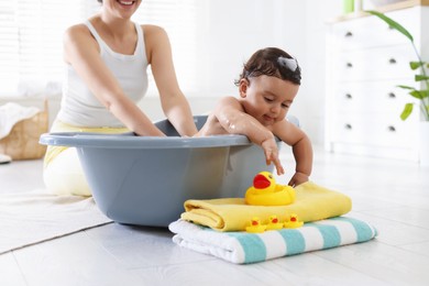 Photo of Mom bathing her little baby at home, closeup