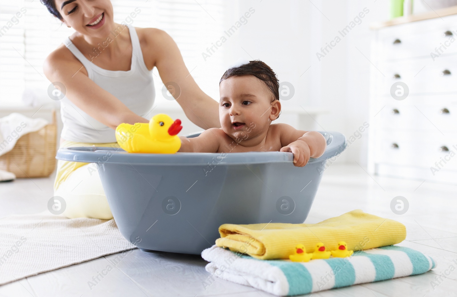 Mom bathing her little baby at home, closeup Photo of Mom bathing her little baby at home, closeup