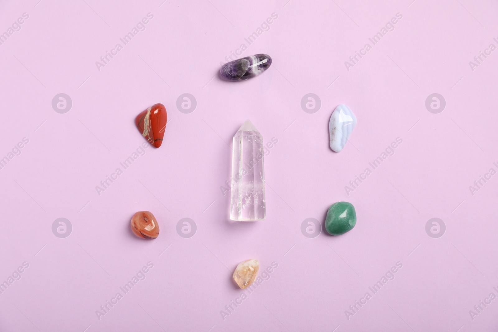 Seven chakra gemstones on lilac background, flat lay Photo of Seven chakra gemstones on lilac background, flat lay