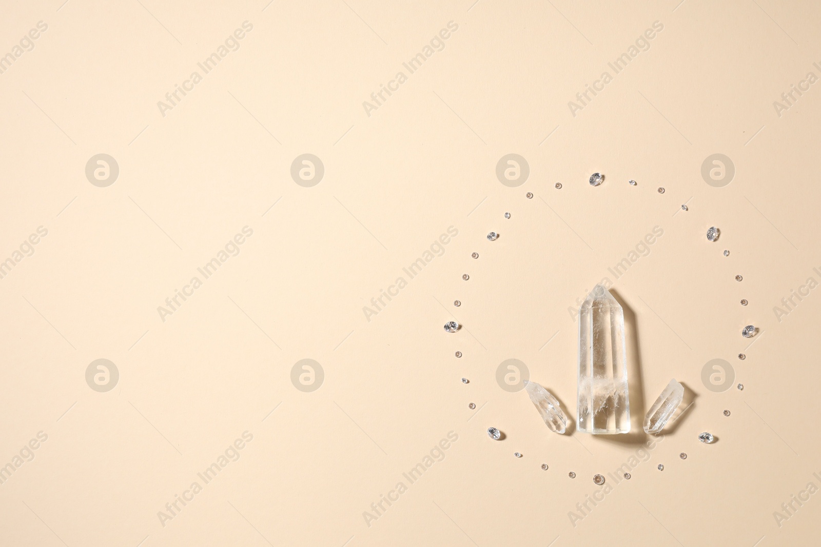 Different gemstones on beige background, flat lay. Space for text Photo of Different gemstones on beige background, flat lay. Space for text