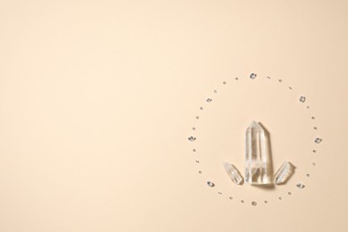 Photo of Different gemstones on beige background, flat lay. Space for text