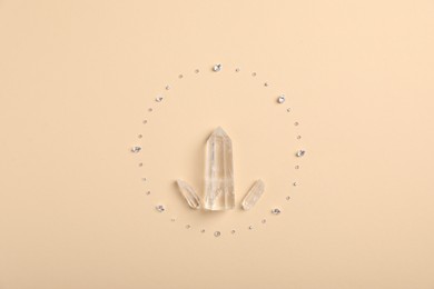 Photo of Different gemstones on beige background, flat lay