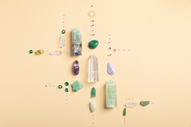 Photo of Different gemstones on beige background, flat lay