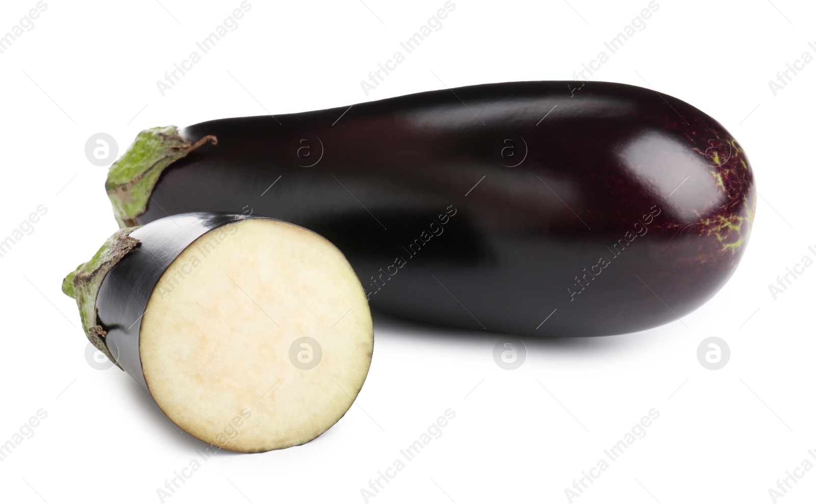 Photo of Whole and cut fresh eggplants isolated on white