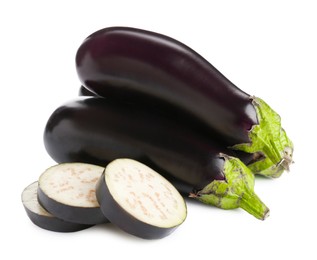 Photo of Whole and cut fresh eggplants isolated on white